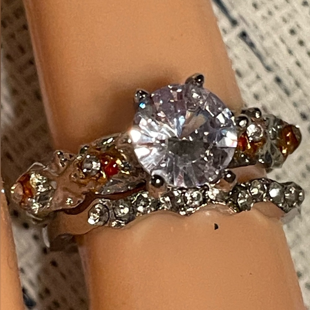 Fashion ring set of 2- silver colored, 1 has large clear stone & other is a band